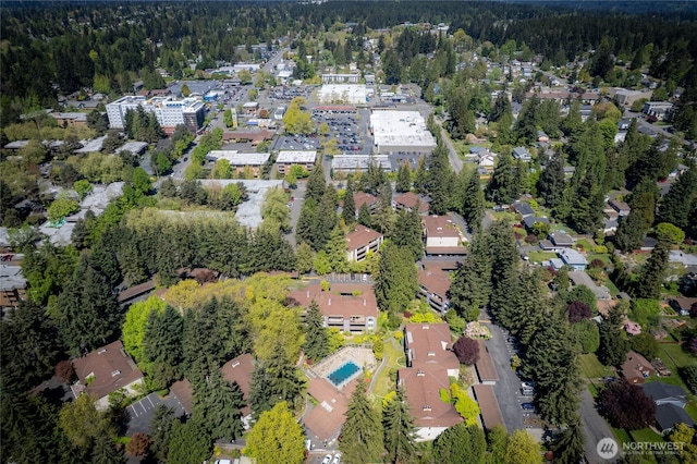 birds eye view of property with a view of trees