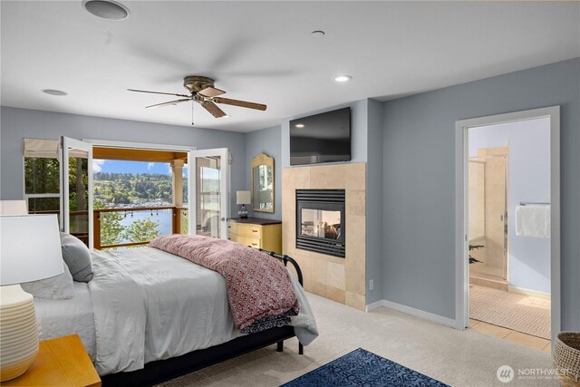 bedroom featuring light colored carpet, recessed lighting, baseboards, a ceiling fan, and a tile fireplace