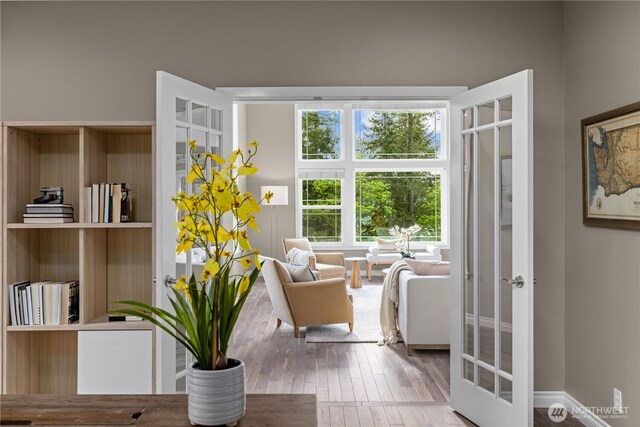 sitting room with french doors and wood finished floors