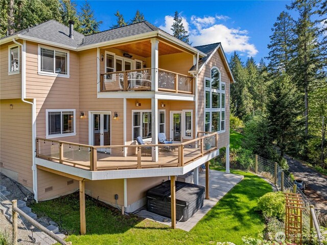 rear view of property with crawl space, fence, a balcony, a yard, and a shingled roof