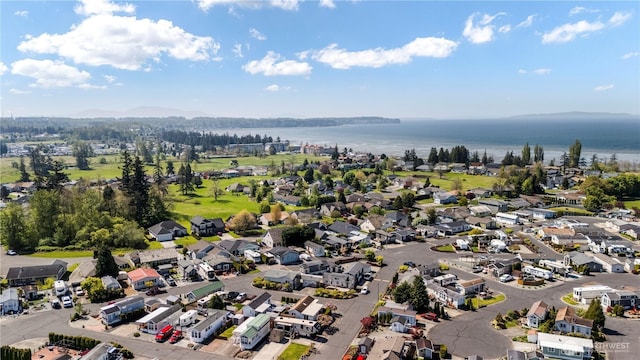 drone / aerial view with a water view and a residential view