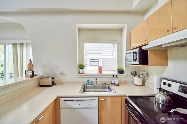425 Vine St Unit 709, Seattle, WA 98121 - kitchen with a sink, plenty of natural light, stainless steel appliances, and under cabinet range hood