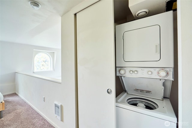 425 Vine St Unit 709, Seattle, WA 98121 - laundry area with laundry area, stacked washing maching and dryer, carpet, baseboards, and visible vents