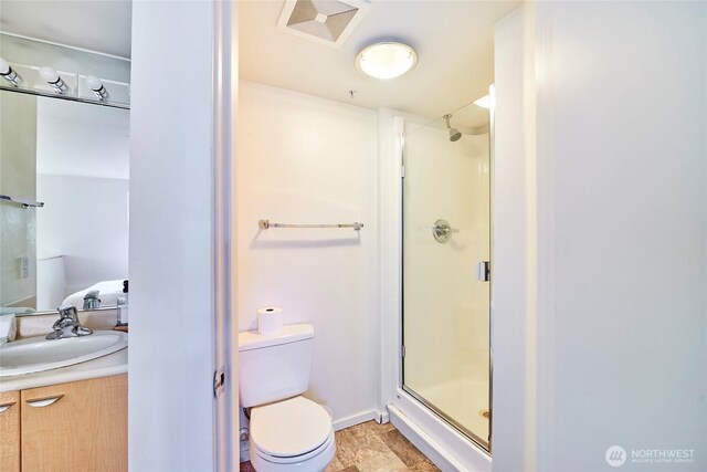 425 Vine St Unit 709, Seattle, WA 98121 - full bathroom featuring vanity, a shower stall, toilet, and visible vents