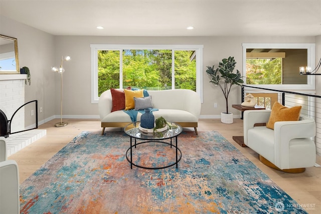 living area featuring a wealth of natural light, baseboards, wood finished floors, and recessed lighting