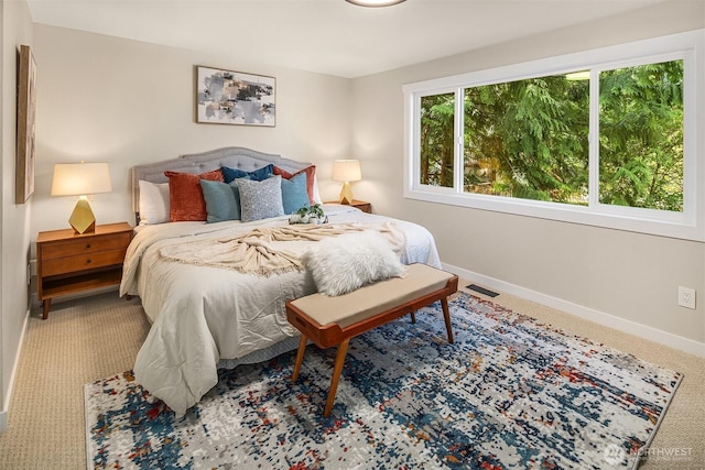 carpeted bedroom featuring visible vents and baseboards