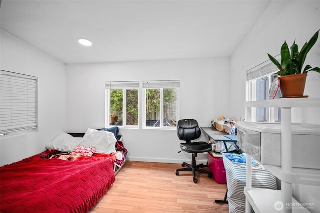 bedroom with baseboards and wood finished floors