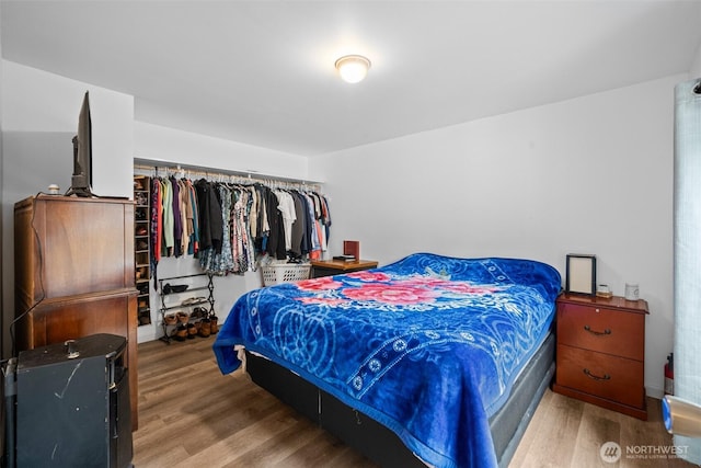 bedroom with wood finished floors