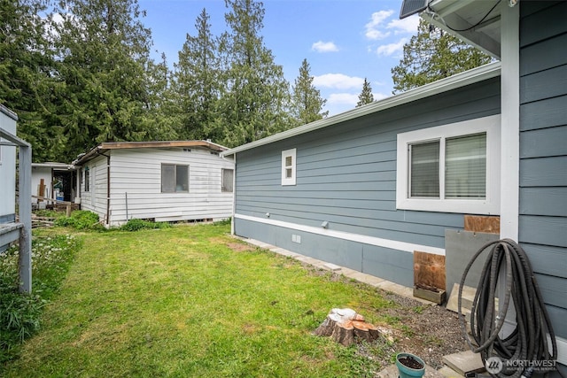 view of home's exterior with a yard and crawl space