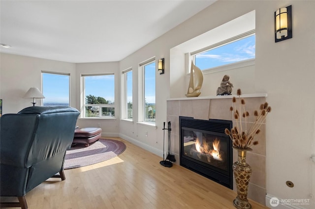 5726 Nakat Way, Blaine, WA 98230 - interior space featuring a tiled fireplace, baseboards, and wood finished floors