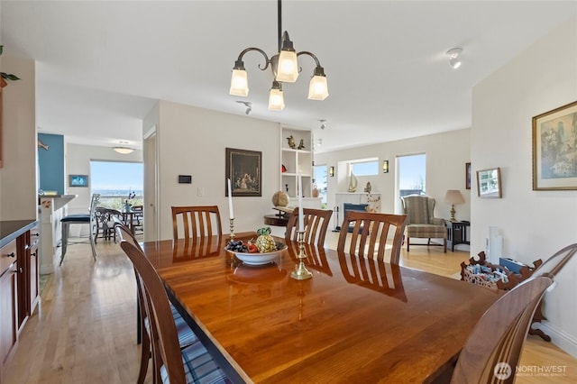 5726 Nakat Way, Blaine, WA 98230 - dining room featuring an inviting chandelier, a healthy amount of sunlight, and light wood-type flooring