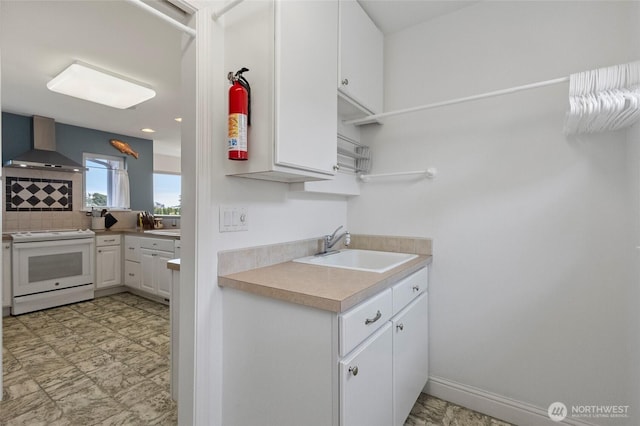 5726 Nakat Way, Blaine, WA 98230 - kitchen with tasteful backsplash, white cabinetry, a sink, white electric range oven, and wall chimney exhaust hood