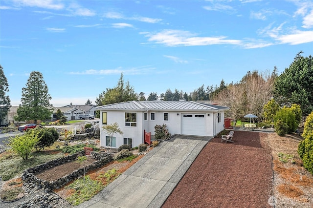 5726 Nakat Way, Blaine, WA 98230 - view of front facade featuring metal roof, concrete driveway, a garage, and a standing seam roof
