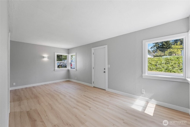 10704 5th Ave S, Tacoma, WA 98444 - unfurnished room featuring baseboards and wood finished floors