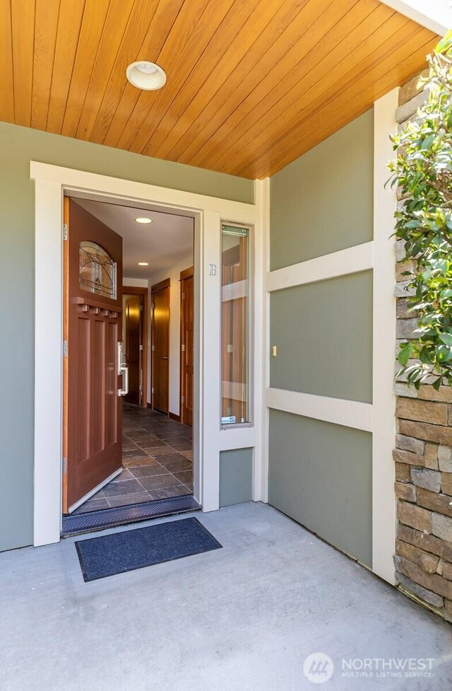 doorway to property featuring stucco siding