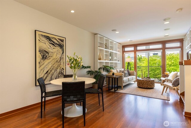 dining space featuring recessed lighting, baseboards, and wood finished floors