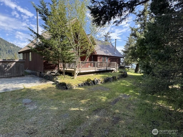 1052 Vusario Ln, Orcas Island, WA 98245 - back of house with a wooden deck and a lawn