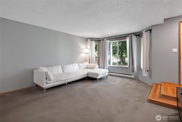 living area with carpet floors, a textured ceiling, and a baseboard heating unit