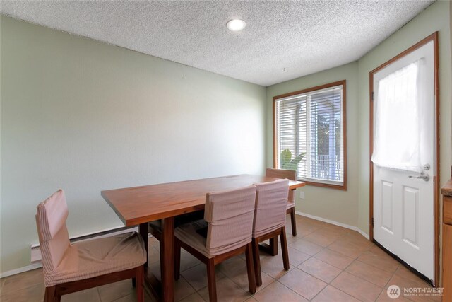 dining space featuring baseboards, recessed lighting, a textured ceiling, and light tile patterned flooring