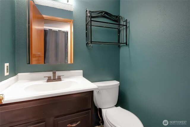 bathroom with vanity and toilet