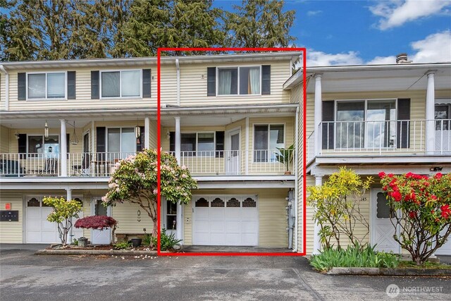 multi unit property featuring driveway and a garage