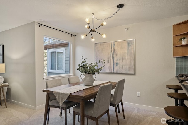 700 Front St S Unit A304, Issaquah, WA 98027 - dining room featuring light colored carpet, baseboards, and a chandelier