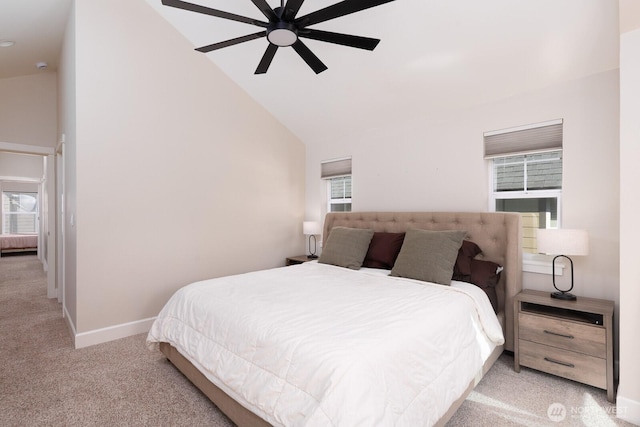 bedroom featuring high vaulted ceiling, multiple windows, baseboards, and light colored carpet