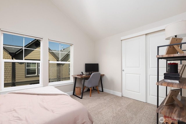 bedroom featuring baseboards, vaulted ceiling, and carpet