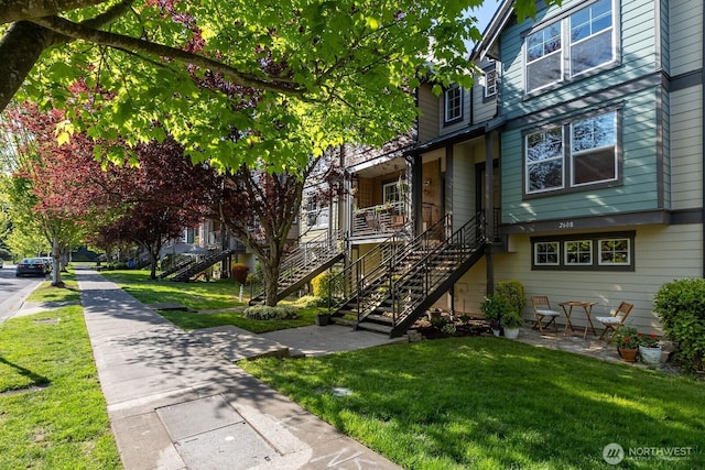 exterior space with stairs and a yard