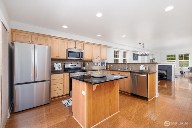 2608 SW Myrtle St, Seattle, WA 98106 - kitchen featuring appliances with stainless steel finishes, a sink, light wood-type flooring, a peninsula, and light brown cabinets