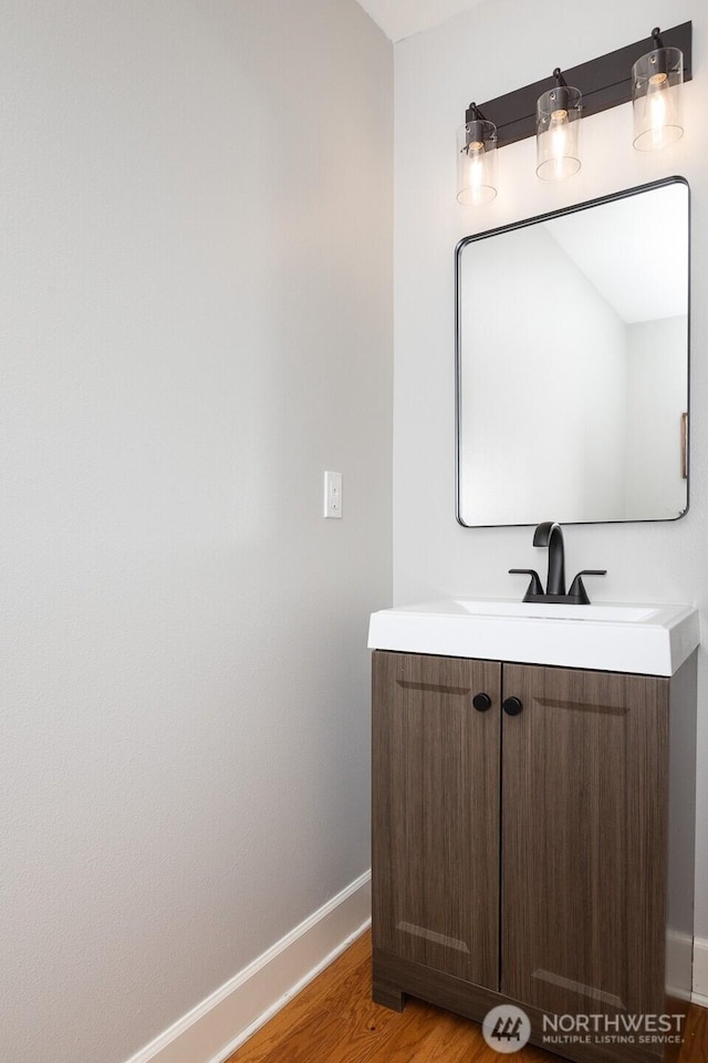 2608 SW Myrtle St, Seattle, WA 98106 - bathroom featuring baseboards, wood finished floors, and vanity