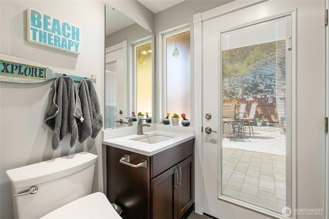 half bath featuring toilet and vanity