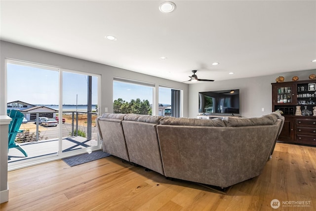 living area featuring recessed lighting, a ceiling fan, and light wood-style flooring