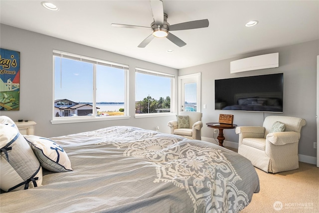 bedroom featuring recessed lighting, a wall mounted air conditioner, and multiple windows