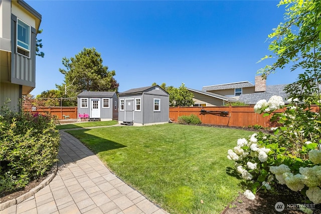 view of yard with an outdoor structure and a fenced backyard