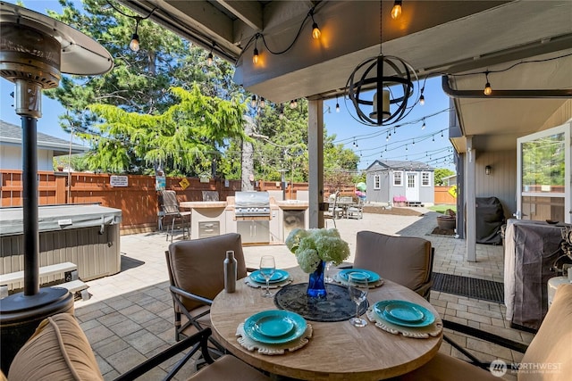 view of patio with outdoor dining area, a hot tub, fence, and grilling area