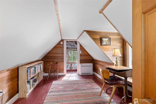 office featuring wooden walls, heating unit, and wood-type flooring