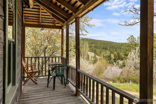 wooden deck featuring a wooded view