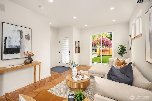 living area featuring recessed lighting, baseboards, visible vents, and a wall unit AC
