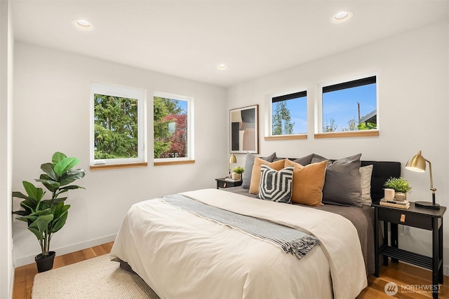bedroom with recessed lighting, baseboards, and wood finished floors