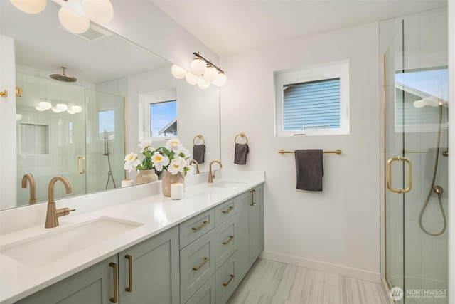 full bathroom featuring double vanity, baseboards, a sink, and a stall shower
