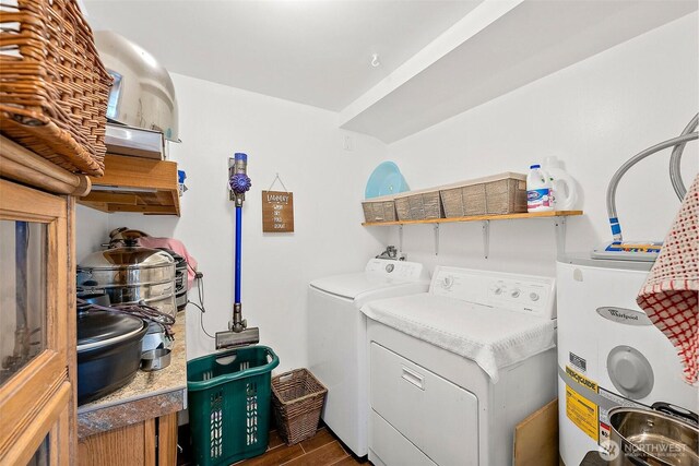 laundry room featuring laundry area, washer and clothes dryer, dark wood-style flooring, and water heater