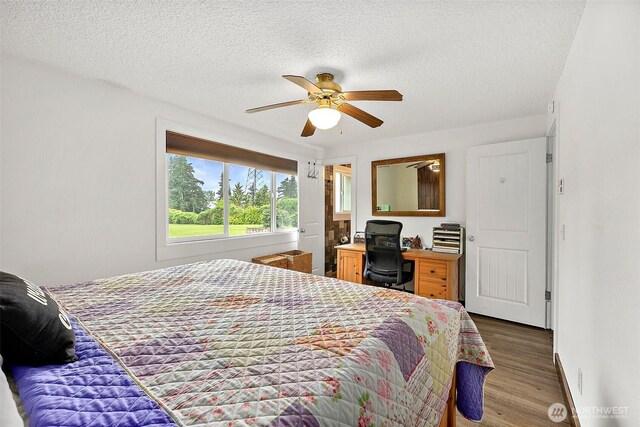 bedroom featuring a textured ceiling, ceiling fan, and wood finished floors