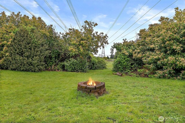 view of yard with a fire pit