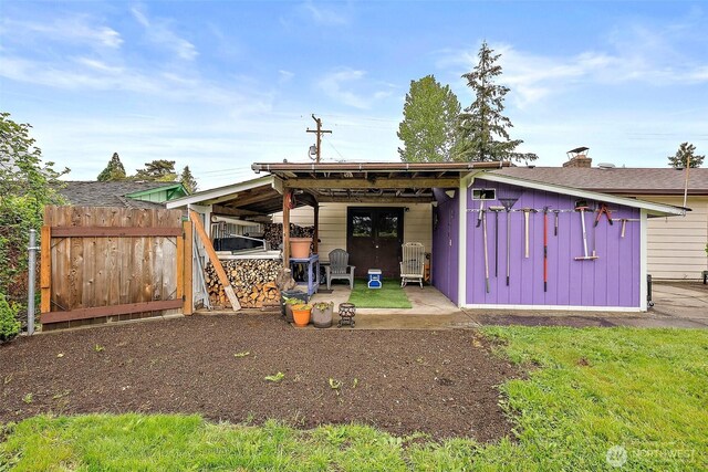 view of outbuilding with fence