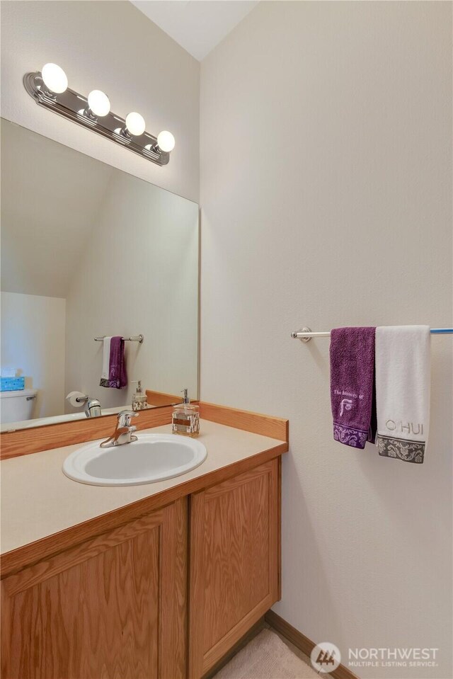 17422 90th Ave E, Puyallup, WA 98375 - bathroom featuring vanity, toilet, and vaulted ceiling
