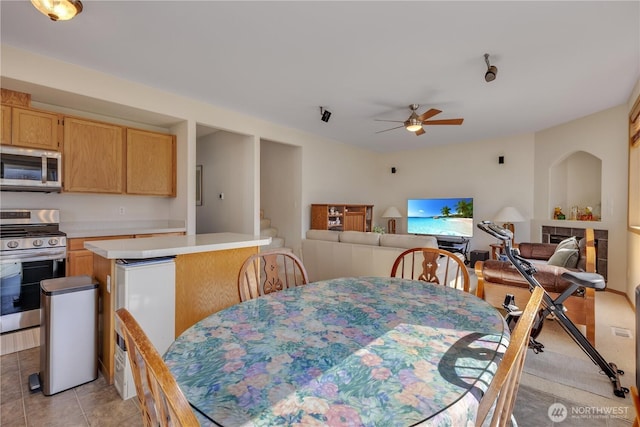 17422 90th Ave E, Puyallup, WA 98375 - dining area featuring a ceiling fan, light tile patterned floors, and stairs