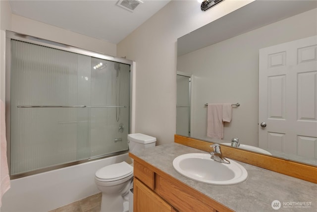 17422 90th Ave E, Puyallup, WA 98375 - full bath with toilet, vanity, tile patterned flooring, and combined bath / shower with glass door