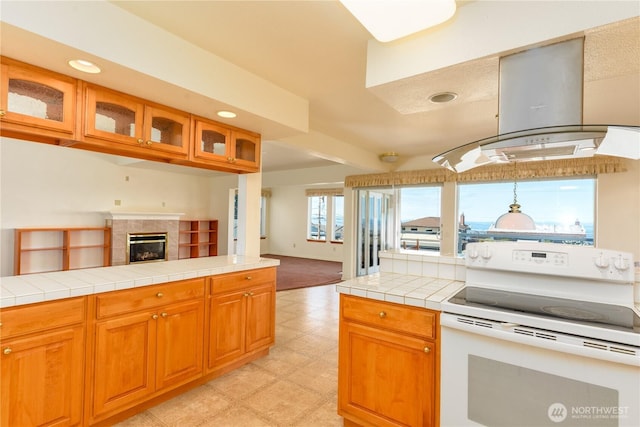 kitchen featuring electric range, island range hood, light flooring, open floor plan, and recessed lighting