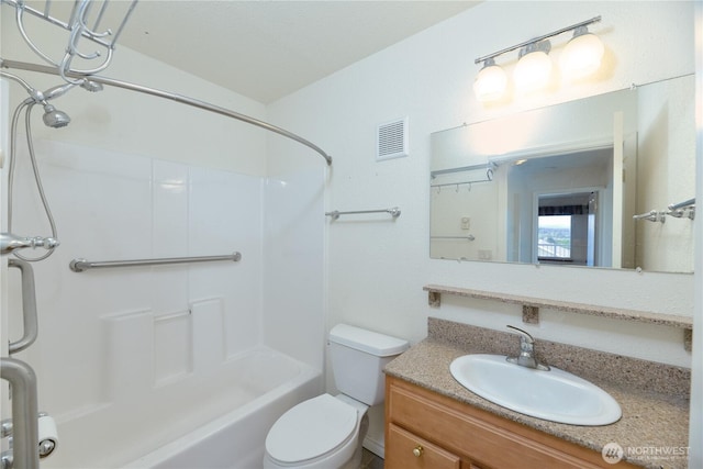 full bathroom featuring toilet, vanity, and tub / shower combination